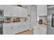 Bright kitchen features white cabinets, stainless steel appliances, marble backsplash and plenty of counter space at 9456 Channing Hill Dr, Sun City Center, FL 33573