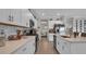 Bright kitchen features white cabinets, stainless steel appliances, marble backsplash and a view into dining area at 9456 Channing Hill Dr, Sun City Center, FL 33573