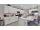 Bright kitchen features white cabinets, stainless steel appliances, marble backsplash and pendant lighting at 9456 Channing Hill Dr, Sun City Center, FL 33573