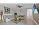 Open-concept living room featuring tile flooring, modern decor, and a large wall-mounted television for entertainment at 9456 Channing Hill Dr, Sun City Center, FL 33573