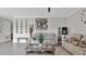 Bright living room featuring tile flooring, modern decor, and a large coffee table for casual gatherings at 9456 Channing Hill Dr, Sun City Center, FL 33573