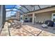 Screened-in patio has brick floors, outdoor furniture, grill, and spa at 9456 Channing Hill Dr, Sun City Center, FL 33573
