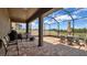 Covered patio with brick flooring, plenty of seating, and an outdoor grill, perfect for entertaining and relaxing at 9456 Channing Hill Dr, Sun City Center, FL 33573