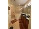 Bathroom featuring double sink vanity with dark countertop, glass shower, and tile floors at 11439 Cambray Creek Loop, Riverview, FL 33579