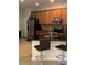 Kitchen with wood cabinets, stainless steel appliances, granite countertops, and breakfast bar with seating at 11439 Cambray Creek Loop, Riverview, FL 33579