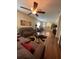 Open concept living room showcasing hardwood floors, neutral walls, stylish furniture, and ample natural light at 11439 Cambray Creek Loop, Riverview, FL 33579