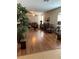 Open living room featuring hardwood floors, neutral walls, modern furniture, and a large potted plant at 11439 Cambray Creek Loop, Riverview, FL 33579