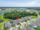 Aerial view of a home nestled in a lush community near a serene lake at 12928 Twin Bridges Dr, Riverview, FL 33579