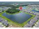 Community aerial view showcasing home near a pond and lush landscaping at 12928 Twin Bridges Dr, Riverview, FL 33579