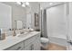 Clean bathroom showcasing modern fixtures, a vanity, and a shower-tub combination with a shower curtain at 12928 Twin Bridges Dr, Riverview, FL 33579