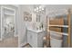 Comfortable bathroom featuring a vanity with a sink and an decorative wall hanging at 12928 Twin Bridges Dr, Riverview, FL 33579