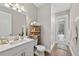 Well-lit bathroom with a single sink vanity, walk-in shower and access to the outdoor patio at 12928 Twin Bridges Dr, Riverview, FL 33579