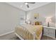 Bright bedroom featuring a bed, bedside tables, and a ceiling fan at 12928 Twin Bridges Dr, Riverview, FL 33579