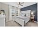 Cozy bedroom featuring a large bed, stylish decor, and plenty of natural light from windows at 12928 Twin Bridges Dr, Riverview, FL 33579