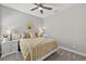Bright bedroom featuring a bed, bedside tables, and a ceiling fan at 12928 Twin Bridges Dr, Riverview, FL 33579