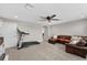 Well-lit bonus room featuring a ceiling fan, adjacent seating area and workout equipment at 12928 Twin Bridges Dr, Riverview, FL 33579