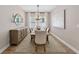 Elegant dining room with a wooden table, patterned rug, and stylish decor at 12928 Twin Bridges Dr, Riverview, FL 33579