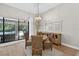 Bright dining room featuring stylish chandelier and sliding glass doors to the pool area at 12928 Twin Bridges Dr, Riverview, FL 33579