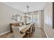 Formal dining area with a long wooden table set for six and decorative wall art at 12928 Twin Bridges Dr, Riverview, FL 33579