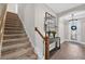 Inviting entryway with chandelier, decor console table with hardwood floors and stairway to the left at 12928 Twin Bridges Dr, Riverview, FL 33579
