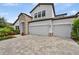 Charming two-story home with stone accents, well-manicured lawn, and three-car garage at 12928 Twin Bridges Dr, Riverview, FL 33579