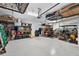 Spacious garage with overhead storage racks and epoxy flooring provides ample storage and workspace at 12928 Twin Bridges Dr, Riverview, FL 33579