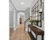 Hallway with wood floors, staircase, and a decorative wall mirror at 12928 Twin Bridges Dr, Riverview, FL 33579