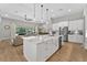 Open-concept kitchen with a large island, stainless steel appliances, and seamless access to living area at 12928 Twin Bridges Dr, Riverview, FL 33579