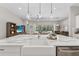 Bright kitchen with a large island, farmhouse sink, open floor plan, and access to the living area and backyard at 12928 Twin Bridges Dr, Riverview, FL 33579