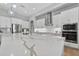 Modern kitchen with a large island, stainless steel appliances, and stylish pendant lighting at 12928 Twin Bridges Dr, Riverview, FL 33579