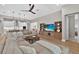 Bright and airy living room featuring a comfortable sectional sofa and entertainment center at 12928 Twin Bridges Dr, Riverview, FL 33579