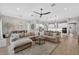 Spacious living room with a large sectional sofa and open view of the kitchen and dining area at 12928 Twin Bridges Dr, Riverview, FL 33579