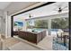 Inviting outdoor living area with a screened-in patio, comfortable seating, and a view of the pool at 12928 Twin Bridges Dr, Riverview, FL 33579