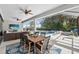 Covered patio with dining table and view of the pool and hot tub overlooking a beautiful yard at 12928 Twin Bridges Dr, Riverview, FL 33579