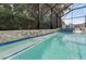 Pool featuring a built-in spa with a waterfall and lush landscaping at 12928 Twin Bridges Dr, Riverview, FL 33579
