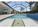Screened in pool with two lounge chairs in the shallow end at 12928 Twin Bridges Dr, Riverview, FL 33579