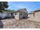 Exterior of home displaying backyard with partial privacy fence, an AC unit and sandy area at 1432 San Juan Ct, Clearwater, FL 33756