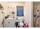 Compact bathroom featuring a shower, toilet, vanity with a mirror, and tiled flooring for easy maintenance at 1432 San Juan Ct, Clearwater, FL 33756