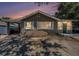 Charming single-story home featuring a covered parking, inviting green door, and lovely front garden at 1432 San Juan Ct, Clearwater, FL 33756