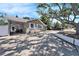 Charming single-story home featuring a covered parking, a well manicured lawn and mature shade trees at 1432 San Juan Ct, Clearwater, FL 33756