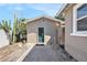Exterior of garage with green door, smooth concrete driveway, and desert foliage at 1432 San Juan Ct, Clearwater, FL 33756