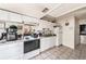 Bright kitchen with tile flooring, white cabinets and appliances along an open wall plan at 1432 San Juan Ct, Clearwater, FL 33756