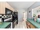 Functional kitchen equipped with modern appliances, tile flooring, and lots of counter space and natural light at 1432 San Juan Ct, Clearwater, FL 33756