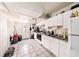 Open kitchen area with tile flooring, white cabinets and appliances, and direct back door access at 1432 San Juan Ct, Clearwater, FL 33756