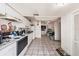 Spacious kitchen with tile flooring, white cabinets and appliances with lots of open space at 1432 San Juan Ct, Clearwater, FL 33756