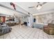 Spacious living area featuring tile floors, ceiling fans, and ample natural light, seamlessly connects to the kitchen at 1432 San Juan Ct, Clearwater, FL 33756
