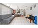Open-concept living room with tile floors, flowing into kitchen, perfect for entertaining and daily living at 1432 San Juan Ct, Clearwater, FL 33756