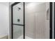 Modern shower with a glass door and sleek tile, perfect for a refreshing experience at 16313 Scaup Duck Ave, Brooksville, FL 34614