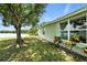 Lush backyard with mature tree and view of a serene lake at 1725 Bondurant Way, Brandon, FL 33511