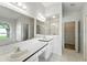 Bright bathroom with double sinks, large mirror, and separate shower and bathtub at 1725 Bondurant Way, Brandon, FL 33511